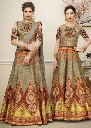 Grab This Beautiful Designer Two In One Lehenga Choli Cum Gown In Olive Green Color. You Can Get This Stitched As A Lehenga Or Floor Length Gown As Per Your Occasion And Convenience. Its Blouse Are Lehenga Are Fabricated On Banarasi Art Silk Beautified With Digital Prints And Embroidery Paired With Chiffon Fabricated Dupatta. Buy This Heavy Designer Piece Now. 