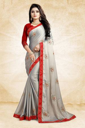Celebrate This Festive Season With Beauty And Comfort Wearing This Designer Saree In Grey Color Paired With Contrasting Red Colored Blouse. This Saree Is Fabricated On Satin Georgette Paired With Art Silk Fabricated Blouse. It Is Beautified With Embroidered Butti All Over.
