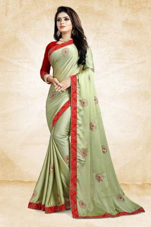 Celebrate This Festive Season With Beauty And Comfort Wearing This Designer Saree In Light Green Color Paired With Contrasting Red Colored Blouse. This Saree Is Fabricated On Satin Georgette Paired With Art Silk Fabricated Blouse. It Is Beautified With Embroidered Butti All Over.