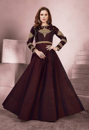 For A Royal Look, Grab This Designer Readymade Gown In Maroon Color Fabricated On Tafeta Silk. It Is Beautified With Attractive Embroidery Over The Yoke And Sleeves. 