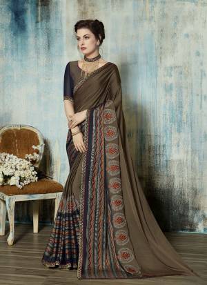 You Will Definitely Earn Lots of Compliments Wearing This Designer Saree In Sand Grey Color Paired With Sand Grey And Navy Blue Colored Blouse. This Saree Is Fabricated On Georgette Paired With Art Silk Fabricated Blouse. 