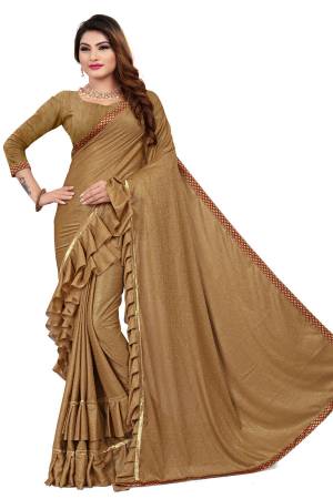 Get Ready For The Upcoming Party At Your place With This Designer Saree In Beige Color Paired With Beige Colored Blouse. This Saree Is Fabricated On Lycra Paired With Art Silk Fabricated Blouse. It Has Pretty Two Layer Frill With Lace Border. Buy This Designer Piece Now. 