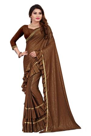 Get Ready For The Upcoming Party At Your place With This Designer Saree In Brown Color Paired With Brown Colored Blouse. This Saree Is Fabricated On Lycra Paired With Art Silk Fabricated Blouse. It Has Pretty Two Layer Frill With Lace Border. Buy This Designer Piece Now. 