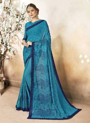 Add This Beautiful designer Saree To Your Wardrobe In Blue Color. This Saree Is Fabricated On Georgette Paired With Art Silk Fabricated Blouse. It Is Beautified With Subtle Tone To Tone Embroidery And Stone Work. 