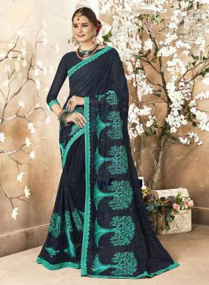 Enhance Your Personality Wearing This Heavy Designer Saree In Navy Blue Color Paired With Navy Blue Colored Blouse. This Saree Is Fabricated On Georgette Paired With Art Silk Fabricated Blouse. It Has Tone To Tone And Contrasting Blue Colored Thread Work Over The Saree. 