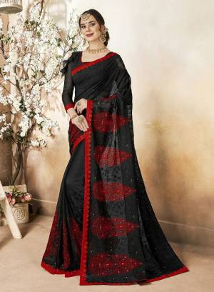 Enhance Your Personality Wearing This Heavy Designer Saree In Black Color Paired With Black Colored Blouse. This Saree Is Fabricated On Georgette Paired With Art Silk Fabricated Blouse. It Has Tone To Tone And Contrasting Blue Colored Thread Work Over The Saree. 