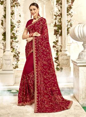 For A Royal Heavy Look, Grab This Designer Saree In Maroon Color Paired With Maroon Colored Blouse. This Saree And Blouse are Georgette Based Beautified With Heavy Jari And Thread Embroidery With Stone Work. Buy Now.