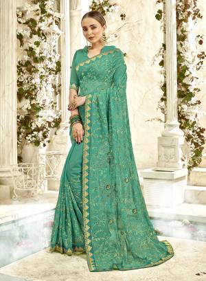 For A Royal Heavy Look, Grab This Designer Saree In Sea Green Color Paired With Sea Green Colored Blouse. This Saree And Blouse are Georgette Based Beautified With Heavy Jari And Thread Embroidery With Stone Work. Buy Now.