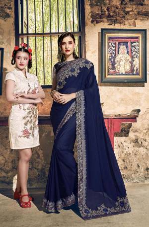 Enhance Your Personality Wearing This Rich Designer Saree In Navy Blue Color Paired With Navy Blue Colored Blouse. This Saree Is Fabricated On Georgette Paired With Art Silk And Net Fabricated Blouse. 