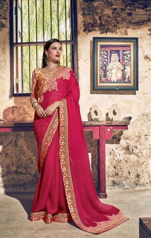 Catch All The Limelight Wearing This Designer Saree In Dark Pink Color Paired With Orange Colored Blouse. This Heavy Embroidered Saree Is Georgette Based paired With Art Silk And Net Fabricated Blouse.