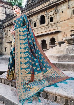 This Festive Season Look The Most Elegant Of All Wearing This Designer Silk based Saree Beautified With Weave. This Banarasi Art Silk Saree Is Light Weight, Durable And Easy To Carry Throughout The Gala
