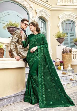Grab This Very Pretty Designer Saree In Dark Green Color Paired With Dark Green Colored Blouse. This Heavy Embroidered Saree IS Fabricated On Chiffon Paired With Art Silk Fabricated Blouse. It Is Beautified With Rich And Subtle Tone To Tone Embroidery With Stone Work. Buy Now.