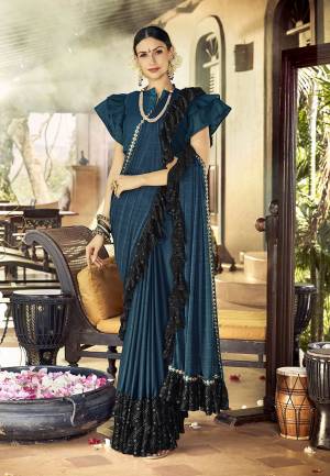 Here Is A Trending Frill Pattern Designer Saree In Blue Color Paired With Blue Colored Blouse. This Saree Is Fabricated On Lycra Paired With Art Silk Fabricated Blouse. It Is Beautified With Frill And Lace Border. 