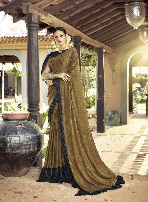 Catch All The Limelight At The Next Party You Attend With This Designer Saree In Dark Beige Color Paired With Black Colored Blouse. This Saree Is Lycra Based Paired Art Silk Fabricated Blouse. It Has Very Beautiful And Trending Frill Border Pattern. Buy This Designer Saree Now.