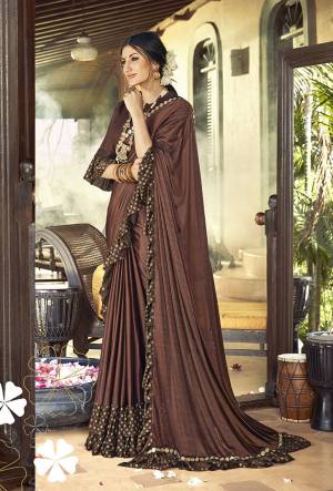 Here Is A Trending Frill Pattern Designer Saree In Dark Brown Color Paired With Dark Brown Colored Blouse. This Saree Is Fabricated On Lycra Paired With Art Silk Fabricated Blouse. It Is Beautified With Frill And Lace Border. 