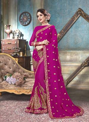 Shine Bright In This Beautiful Designer Saree In Rani Pink Color Paired With Rani Pink Colored Blouse. This Saree And Blouse Are Georgette Based Beautified With Jari And Thread Embroidery With Stone Work.