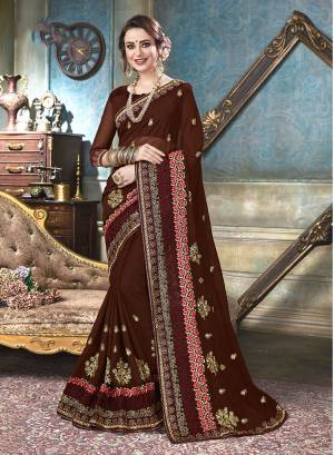 For A Royal Look, Grab This Designer Saree In Brown Color Paired With Brown Colored Blouse. This Saree And Blouse Are Georgette Based Beautified With Heavy And Attractive Embroidery All Over. 