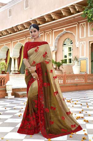 Shades Are Always In So Grab This Designer Shaded Saree In Beige And olive Green Color Paired With Contrasting Red Colored Blouse. This Saree Is Fabricated On Vichitra Silk Paired With Art Silk Fabricated Blouse. It Is Beautified With Subtle Thread Work. 