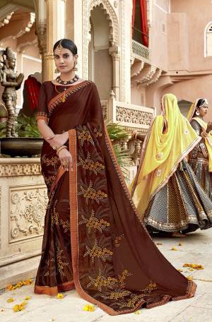Adorn The Pretty Angelic Look In This Designer Brown Colored Saree Paired With Brown Colored Blouse. This Pretty Embroidered Saree In Georgette Based Paired With Art Silk Fabricated Blouse. 