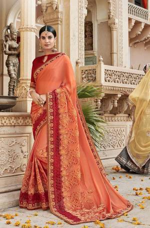 This Festive Season Be The Most Stunning Amongst All Wearing This Designer Saree In Dark Peach Color Paired With Contrasting Red Colored Blouse. This Saree Is Fabricated On Georgette Paired With Art Silk Fabricated Blouse. 