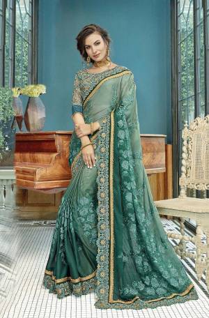 Catch All The Limelight At The Next Wedding You Attend With This Designer Shaded Saree In Shades Pastel And Teal Green Color. This Heavy Embroidered Saree Is Georgette Based Paired With Art Silk And Net Fabricated Blouse. 