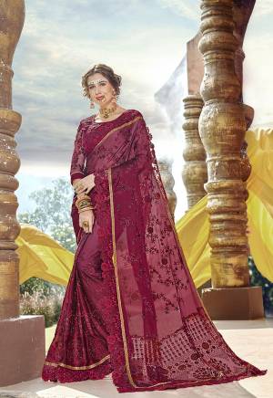 Adorn The Pretty Angelic Look In This Heavy Designer Maroon Colored Saree Paired With Maroon Colored Blouse., This Saree Is Georgette Based Paired With Art Silk And Net Fabricated Blouse. Its Saree And Blouse Are Beautified With Heavy Embroidery. 