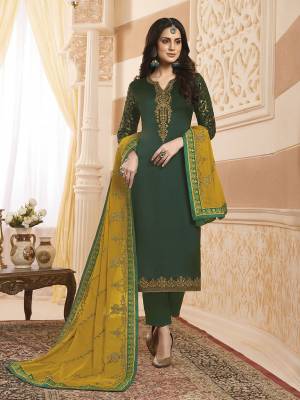 Celebrate This Festive Season Wearing This Designer Straight Suit In Dark Green Colored Top And Bottom Paired With Contrasting Yellow Colored Dupatta. Its Pretty Embroidered Top Is Satin Georgette Based Paired With Santoon Bottom And Georgette Fabricated Dupatta. 