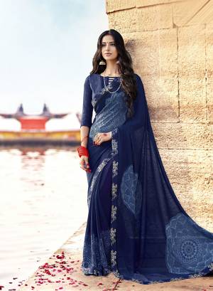 Enhance Your Personality In This Light Weight And Comfortable Georgette Based Saree In Navy Blue Color Paired With Navy Blue Colored Blouse. It Is Beautified With Prints And Lace Border. Buy Now.