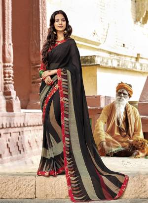 Enhance Your Personality In This Light Weight And Comfortable Georgette Based Saree Black Color Paired With Red Colored Blouse. It Is Beautified With Prints And Lace Border. Buy Now.
