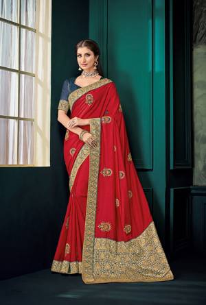 Here Is A Must Have Silk Based Designer Saree In Red Color Paired With Contrasting Navy Blue Colored Blouse. This Saree Is Fabricated On Art Silk And Jacquard Silk Pallu Paired With Art Silk Fabricated Blouse. It Is Beautified With Embroidered Butti All Over It.