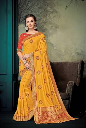 Celebrate This Festive Season With Beauty And Comfort Wearing This Designer Saree In Musturd Yellow Color Paired With Contrasting Orange Colored Blouse. This Saree And Blouse are Silk Based With Jacquard Silk Pallu. Buy This Designer Piece For A Proper Traditional Wear. 
