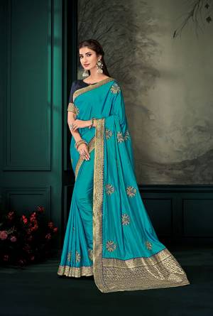 Here Is A Must Have Silk Based Designer Saree In Blue Color Paired With Contrasting Navy Blue Colored Blouse. This Saree Is Fabricated On Art Silk And Jacquard Silk Pallu Paired With Art Silk Fabricated Blouse. It Is Beautified With Embroidered Butti All Over It.