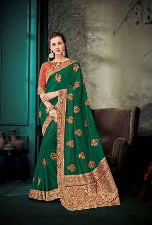Enhance Your Personality Wearing This Designer Silk Based Saree In Dark Green Color Paired With Rust Orange Colored Blouse, This Saree And Blouse Are Silk Based With Highligted Jacquard Silk Pallu. It Has Pretty Embroidered Butti All Over It.