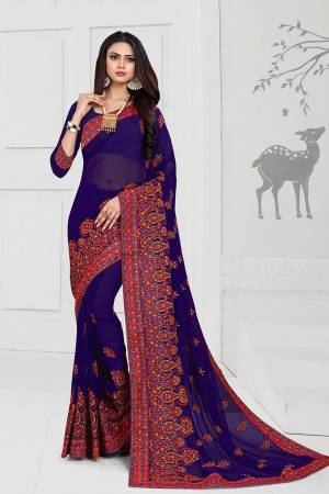 Get Ready For The Upcoming Festive And Wedding Season With This Heavy Deisgner Saree In Royal Blue Color Paired With Royal Blue Colored Blouse. This Saree And Blouse Are Fabricated On Georgette Beautified With Heavy Resham And Stone Work With Contrasting Thread Colors.