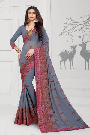Get Ready For The Upcoming Festive And Wedding Season With This Heavy Deisgner Saree In Grey Color Paired With Grey Colored Blouse. This Saree And Blouse Are Fabricated On Georgette Beautified With Heavy Resham And Stone Work With Contrasting Thread Colors.