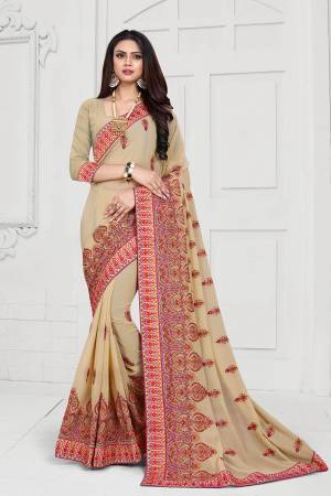 Get Ready For The Upcoming Festive And Wedding Season With This Heavy Deisgner Saree In Beige Color Paired With Beige Colored Blouse. This Saree And Blouse Are Fabricated On Georgette Beautified With Heavy Resham And Stone Work With Contrasting Thread Colors.