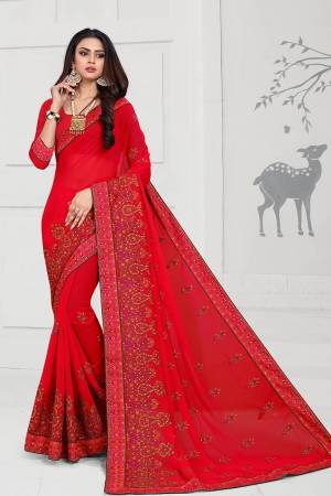 Get Ready For The Upcoming Festive And Wedding Season With This Heavy Deisgner Saree In Red Color Paired With Red Colored Blouse. This Saree And Blouse Are Fabricated On Georgette Beautified With Heavy Resham And Stone Work With Contrasting Thread Colors.