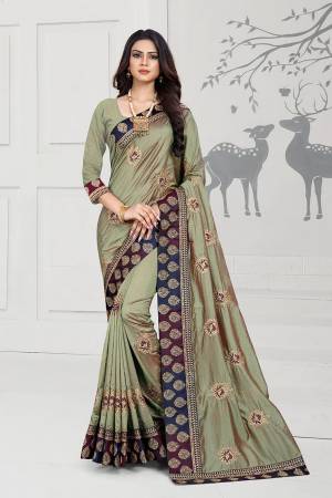 Rich And Elegant Looking Designer Silk Based Saree Is Here In Olive Green Color Paired With Olive Green Colored Blouse. This Saree And Blouse Are Fabricated On Art Silk Beautified With Embroidered Butti And Attractive Lace Border. 