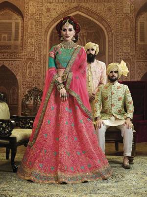 Bright And Appealing Color Pallete Is Here With This Heavy Designer Lehenga Choli In Turquoise Blue Colored Blouse Paired With Contrasting Dark Pink Colored Lehenga And Dupatta. Its Embroidered Blouse Is Fabricated On Art Silk Paired With Orgenza Silk Fabricated Lehenga And Dupatta. Buy Now.
