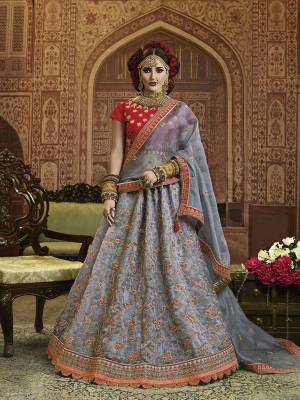 You Will Definitely Earn Lots Of Compliments Wearing This Heavy Designer Lehenga Choli In Red Colored Blouse Paired With Contrasting Grey Colored Lehenga And Dupatta, Its Blouse Is Silk Based Paired With Orgenza Silk Fabricated Lehenga And Dupatta. Buy Now.