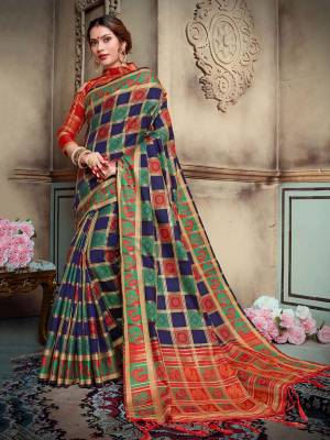 Celebrate This Festive Season With Beauty And Comfort Wearing This Designer Silk Based Saree In Navy Blue And Green Color Paired With Contrasting Rust Orange Colored Blouse. This Saree And Blouse are Fabricated On Lichi Art Silk Beautified With Weave All Over.  Buy This Saree Now.