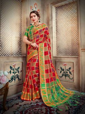 Go Colorful With This Designer Silk Based Saree In Red And Purple Color Paired With Contrasting Green Colored Blouse. This Saree And Blouse Are Fabricated On Lichi Art Silk Beautified With Weave All Over. 