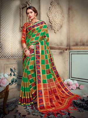 Celebrate This Festive Season With Beauty And Comfort Wearing This Designer Silk Based Saree In Green Color Paired With Contrasting Orange Colored Blouse. This Saree And Blouse are Fabricated On Lichi Art Silk Beautified With Weave All Over.  Buy This Saree Now.