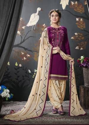 This Festive Season, Adorn A Simple And Comfortable Suit Which Is In Magenta Pink Colored Top Paired With Contrasting Cream Colored Bottom And Dupatta. Its Embroidered Top Is Fabricated On Cotton Silk Paired With Rayon Bottom And Chiffon Fabricated Dupatta. 
