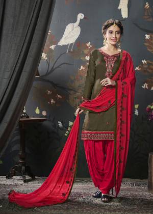 Grab This Very Pretty Designer Straight Suit In Dark Olive Green Colored Top Paired With Contrasting Red Colored Bottom And Dupatta. Its Top Is Fabricated On Cotton Silk Paired With Rayon Bottom And Chiffon Fabricated Dupatta. Buy Now.