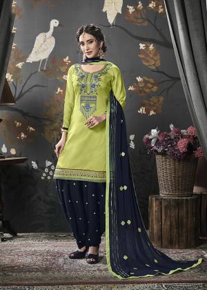 Enhance Your Personality In This Designer Heavy Embroidered Suit In Light Green Color Paired With Contrasting Navy Blue Colored Bottom And Dupatta. Its Top Is Fabricated On Cotton Silk Paired With Rayon Bottom And Chiffon Fabricated Dupatta. 