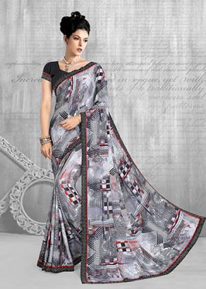 Add This Pretty Saree To Your Wardrobe In Grey & Black Color Paired With Black Colored Blouse. This Saree And Blouse Are Fabricated On Crepe Beautified With Abstract Prints All Over It. Buy Now.