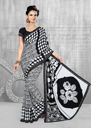 Add This Pretty Saree To Your Wardrobe In Black & White Color Paired With Black Colored Blouse. This Saree And Blouse Are Fabricated On Crepe Beautified With Abstract Prints All Over It. Buy Now.
