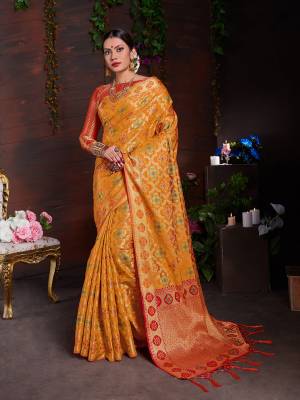 Celebrate This Festive Season With Beauty And Comfort Wearing This Designer Saree In Musturd Yellow Color Paired With Contrasting Orange Colored Blouse. This Saree And Blouse are Art Silk Based Beautified With Heavy Weave. 