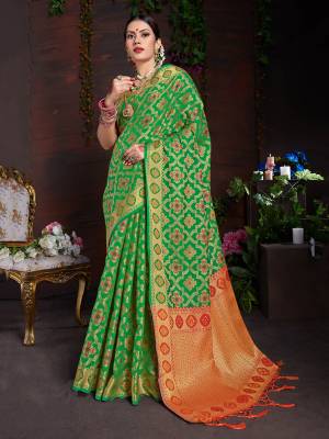 Celebrate This Festive Season With Beauty And Comfort Wearing This Designer Saree In Green Color Paired With Contrasting Orange Colored Blouse. This Saree And Blouse are Art Silk Based Beautified With Heavy Weave. 